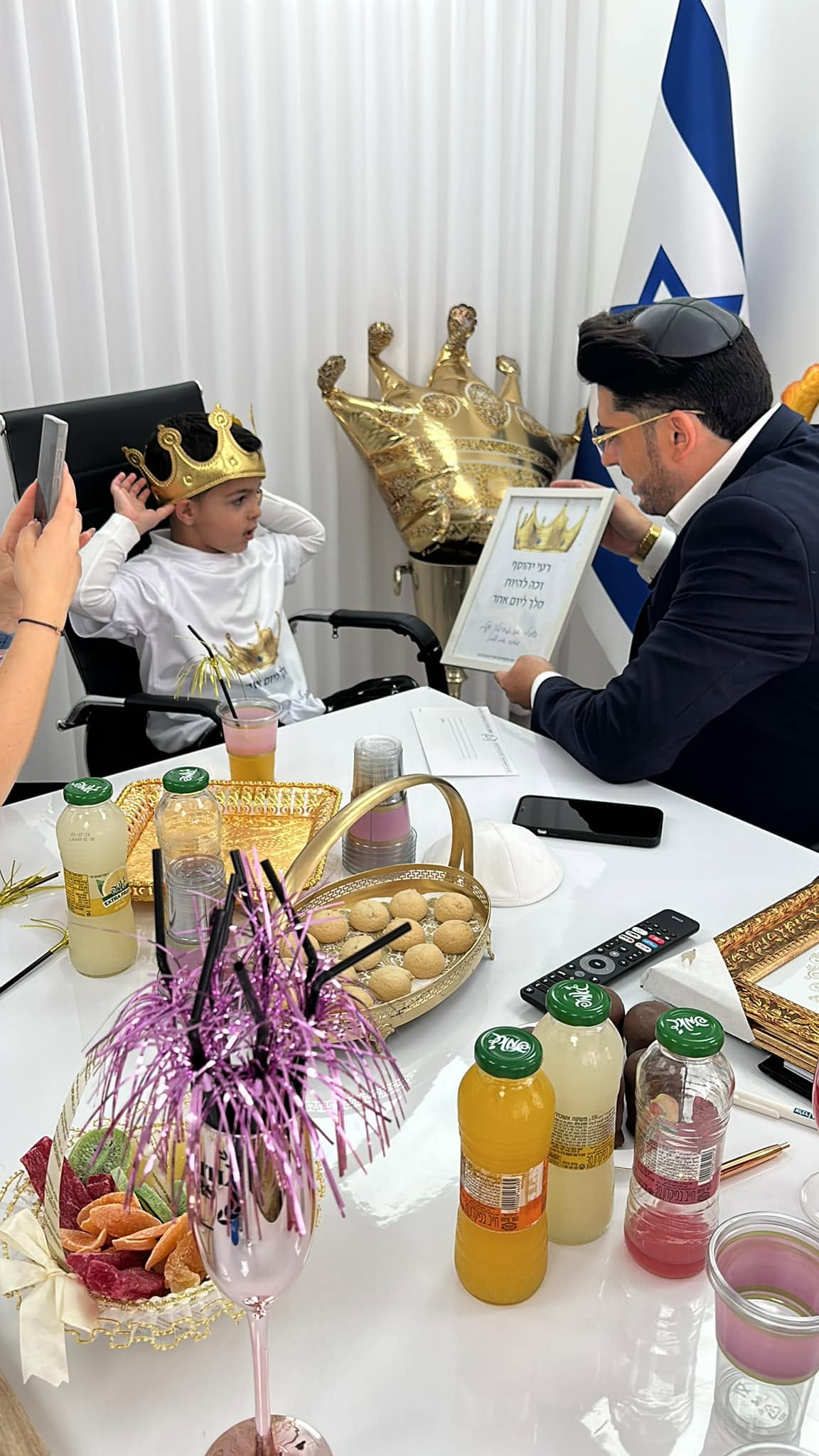 משפחה מקבלת שי במסגרת יום הפעילות במשרדי קפיטל קארס